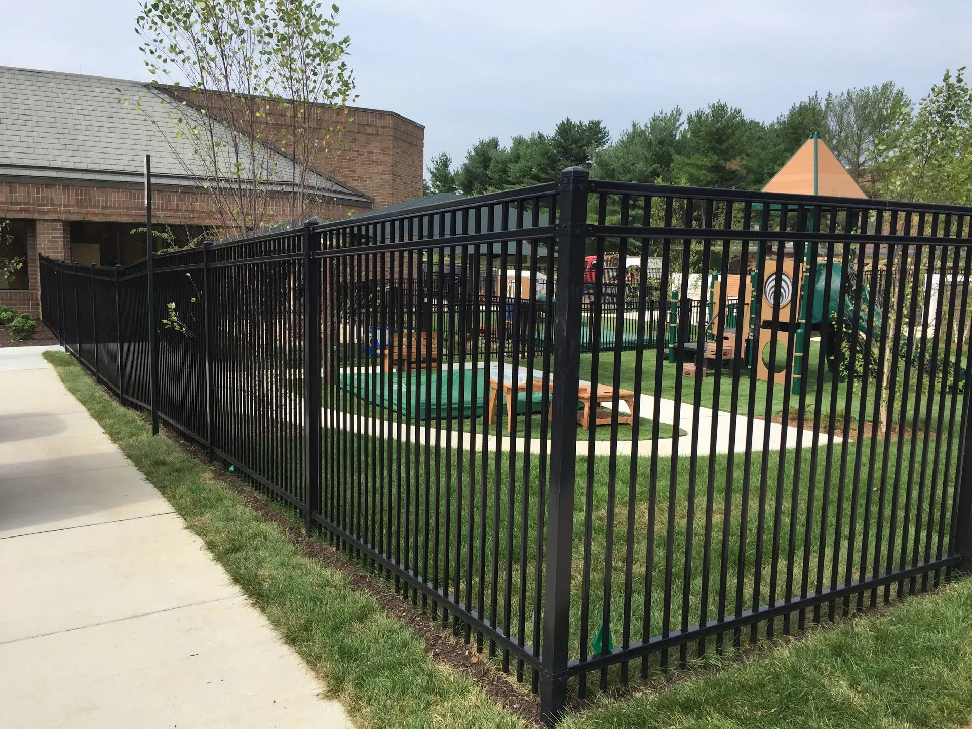 Black aluminum commercial fence installed by Braun Construction in Massachusetts