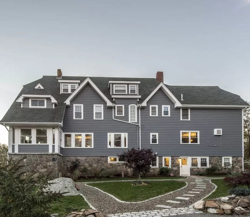 Large commercial-scale gray clapboard building repainted by Braun Construction in Centerville, MA